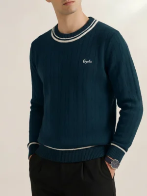 Men's teal cable knit sweater with cream-tipped crew neck, front view.webp