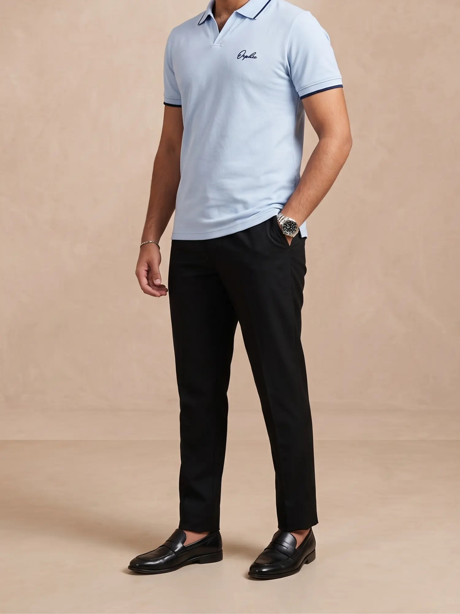 Model wearing Orphic men's sky blue tipped piqué polo with black trousers, front view