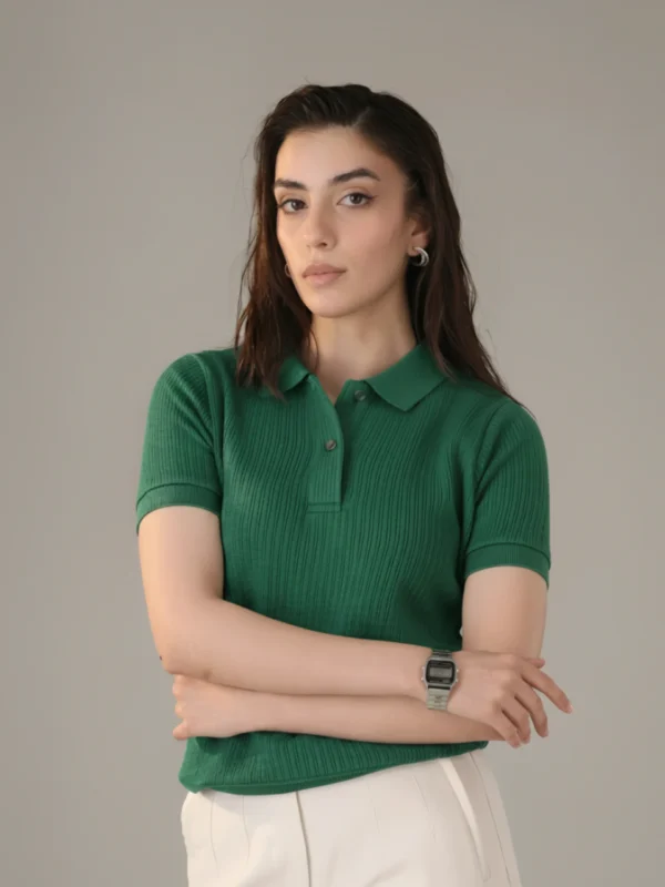 Woman wearing Orphic emerald green ribbed polo, front view.webp