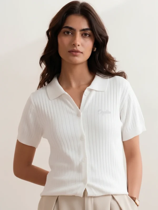 Women's white ribbed knit polo front view with open collar and cream Orphic embroidery.webp