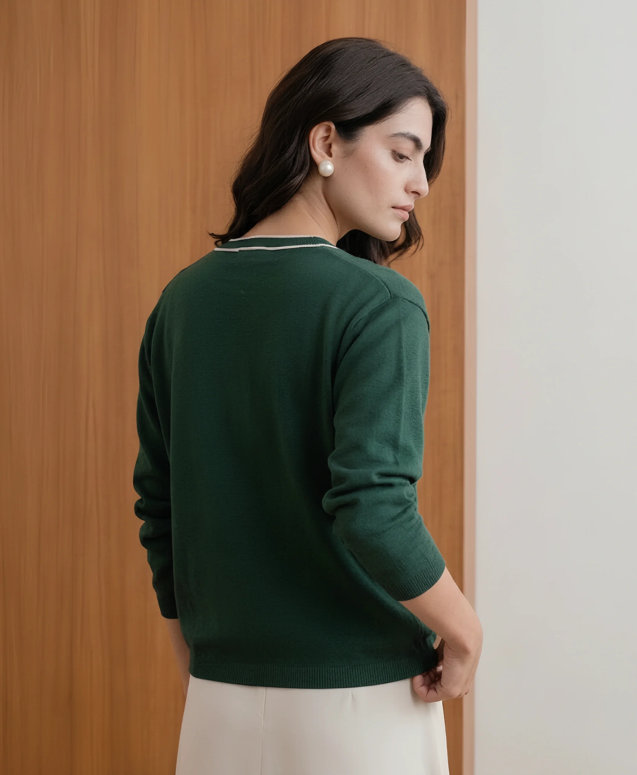 Women's green cardigan back view showing knit and fit.webp