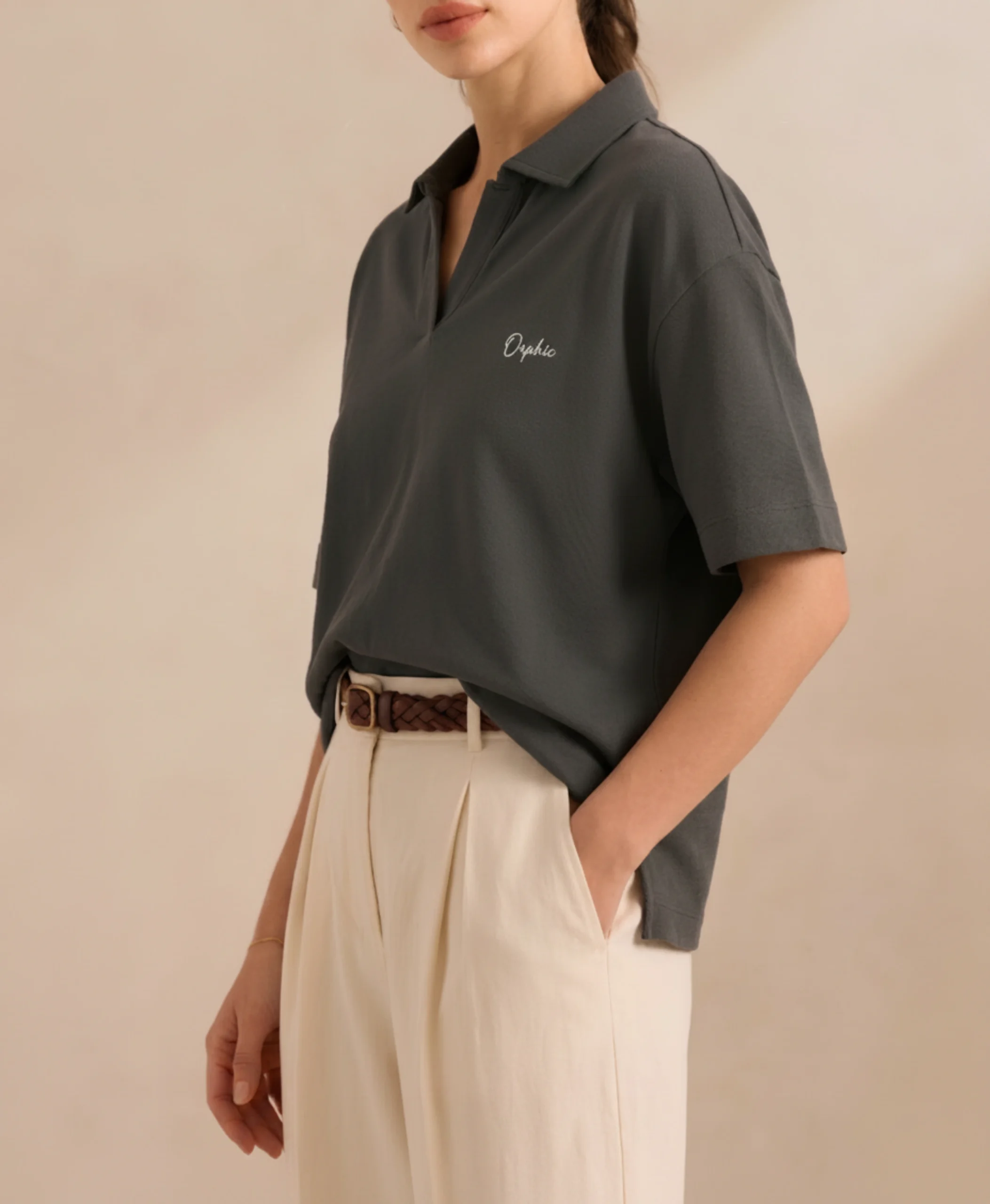 Women's charcoal polo with open collar, side view showing relaxed fit.webp