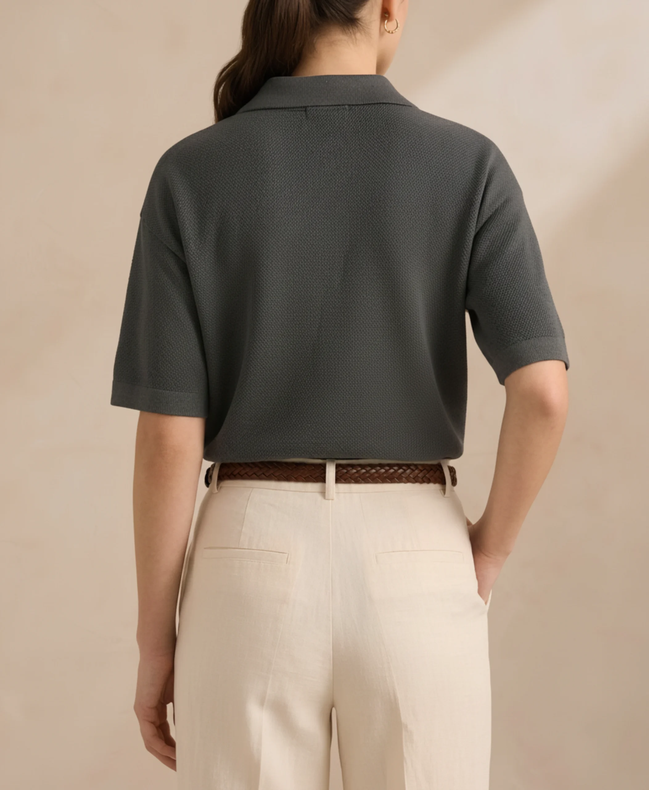 Back view of women's charcoal polo in textured knit.webp
