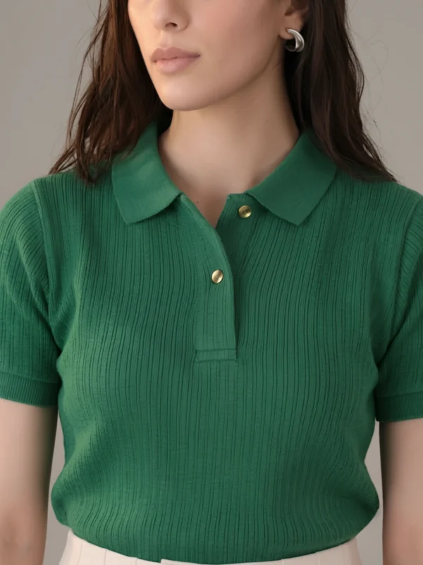lose-up of women's emerald polo showing rib knit, collar and gold button.webp
