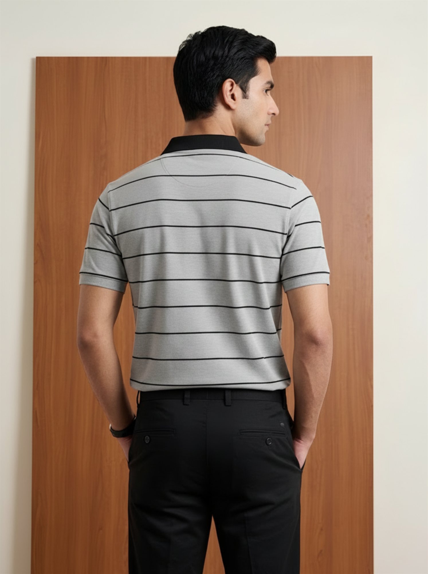 Back view of Orphic men's grey striped polo with black collar and black stripes