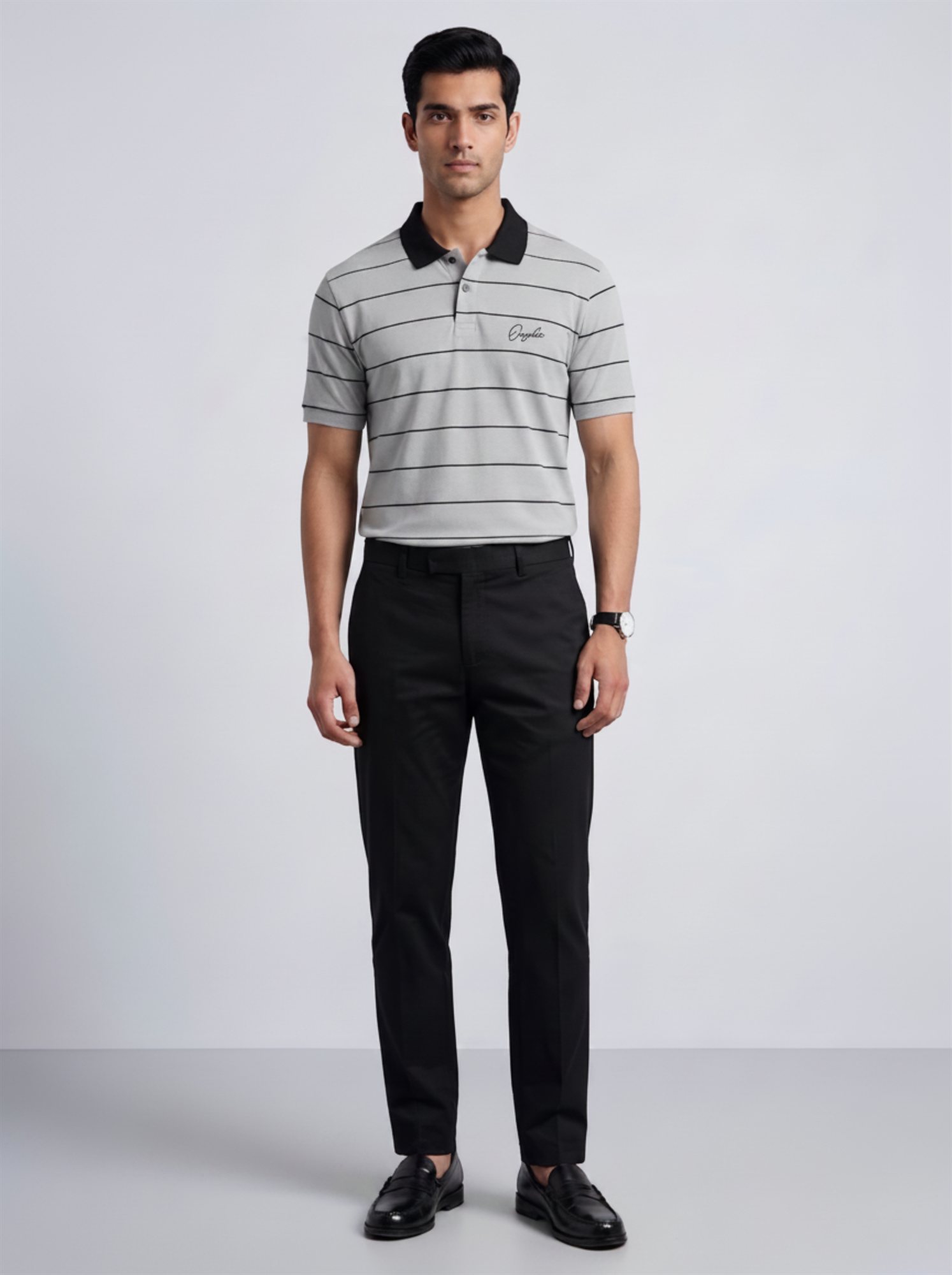 Model wearing Orphic men's grey striped polo with black collar, front view with black trousers