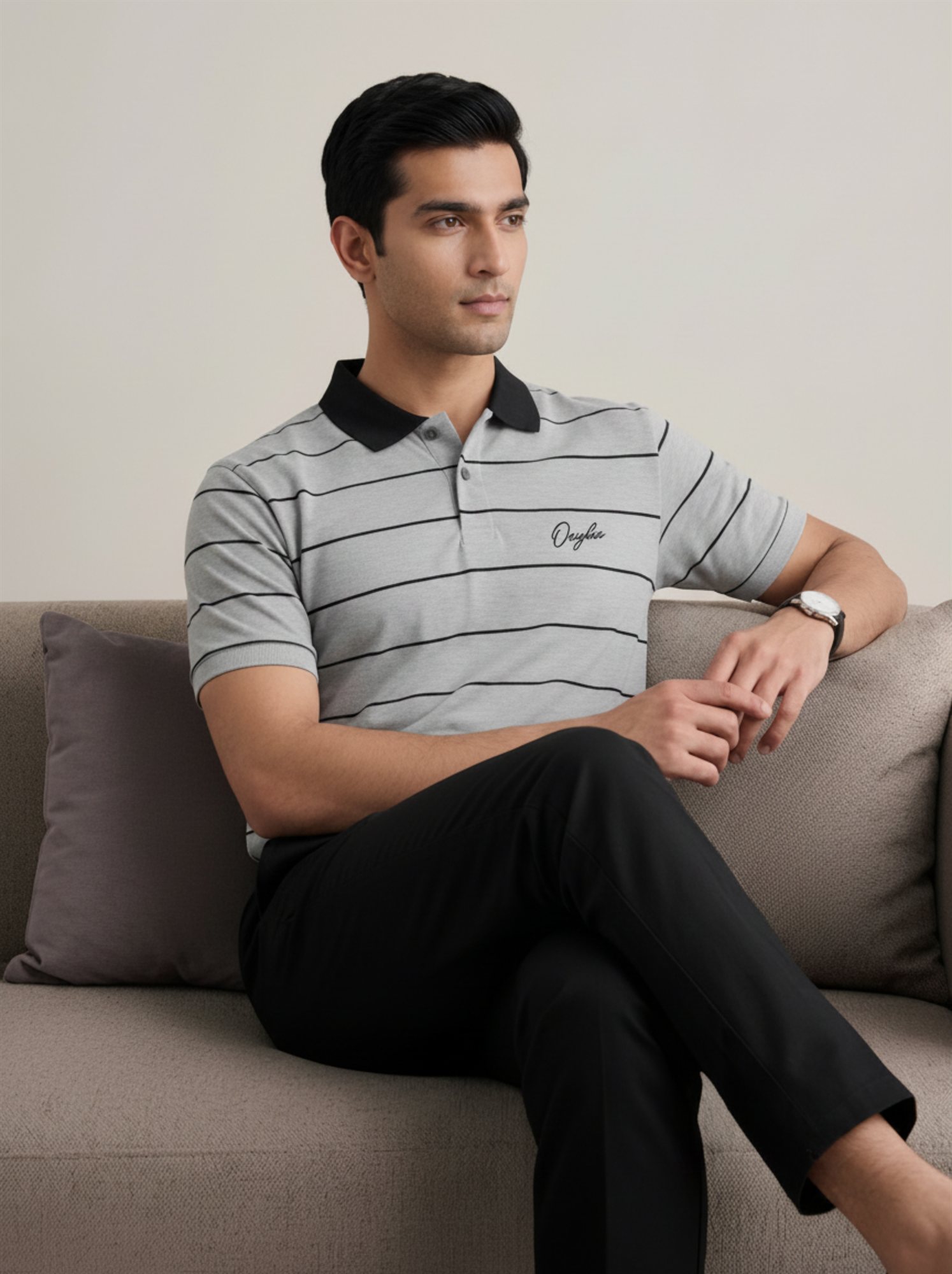 Orphic men's grey and black striped polo shown on seated model