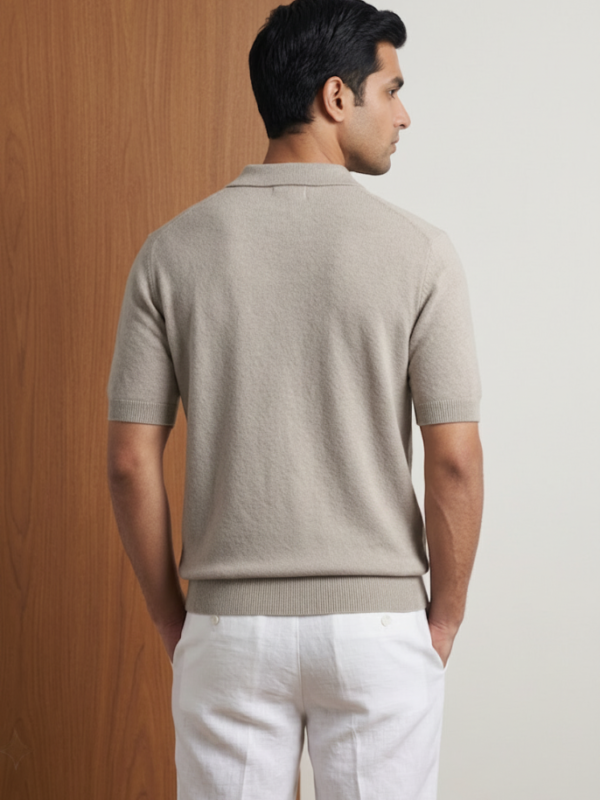 Back view of Orphic men's oatmeal knit quarter-zip polo, worn by model with white trousers