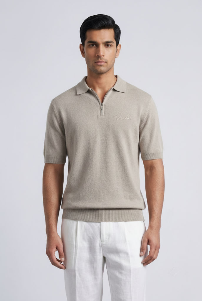 Model wearing Orphic men's oatmeal knit quarter-zip polo, front view with white trousers