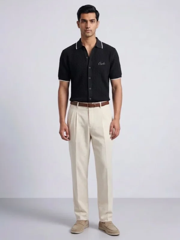 Men's black knit polo with cream-tipped collar, front view