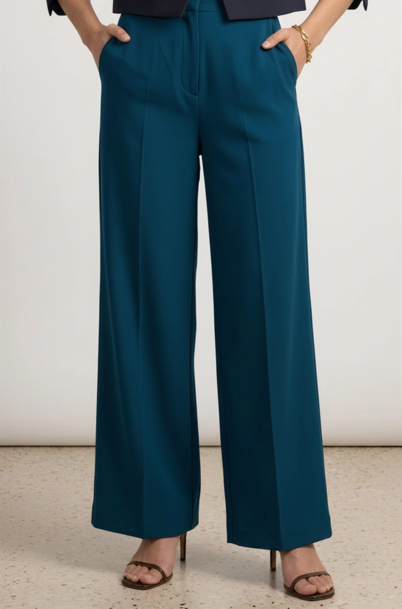 Women's teal trousers waist and pleat detail with side pockets