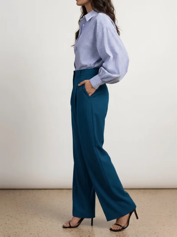 womens-teal-trousers-side.webp Women's teal wide-leg trousers side view showing long fluid leg