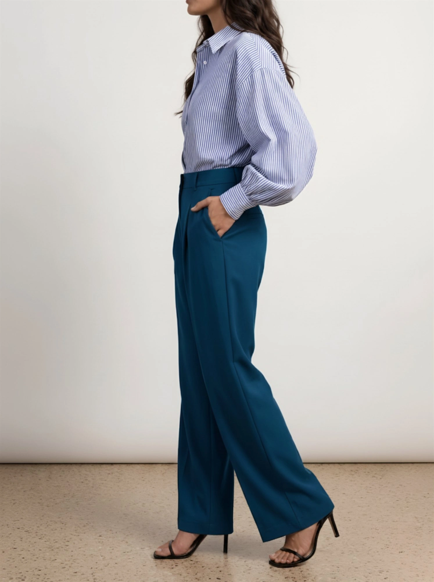 Women's teal wide-leg trousers side view showing long fluid leg
