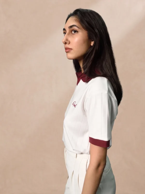 womens-white-drop-needle-polo-front-angle Women's white drop needle polo with oxblood collar, angled view