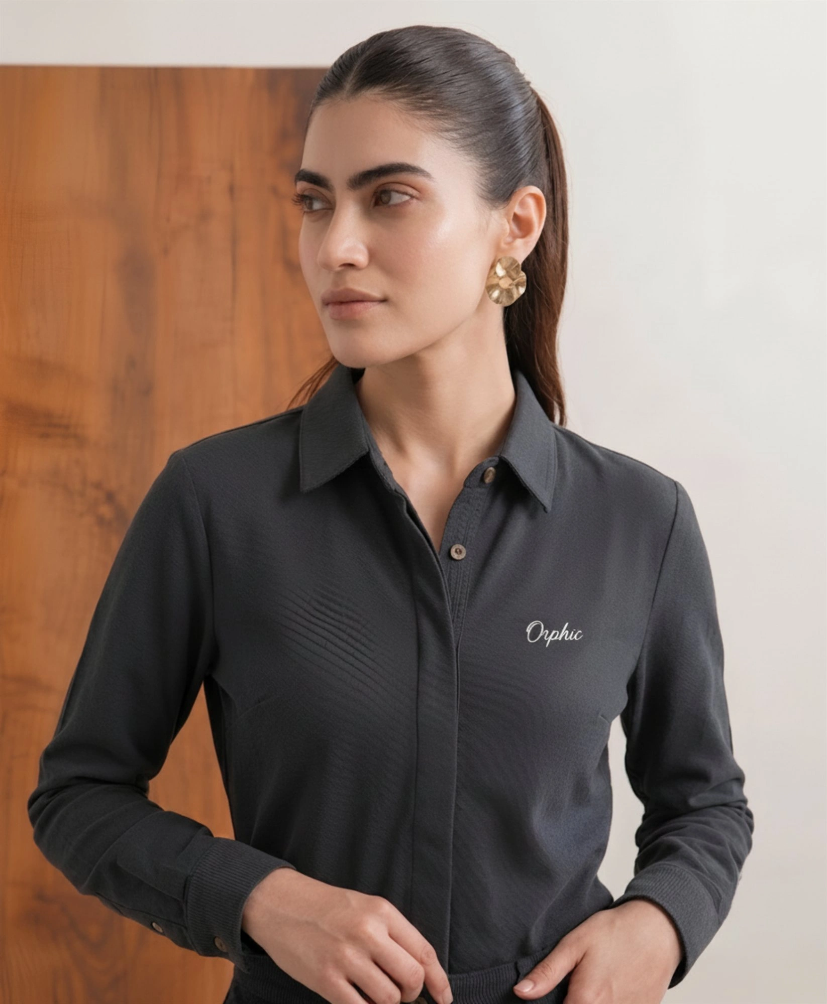 Women's charcoal knit shirt angled view showing button placket
