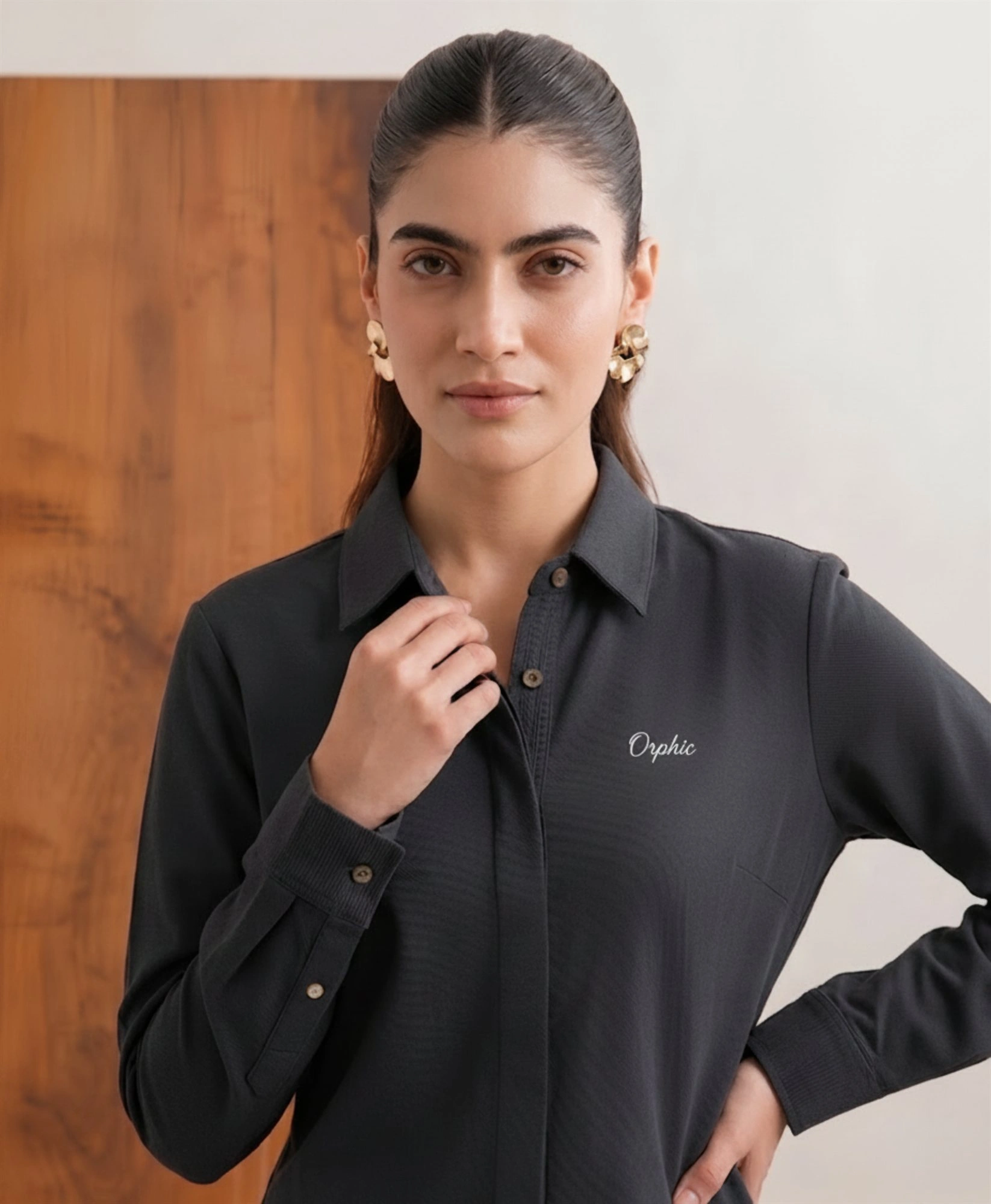Women's charcoal knit shirt front view with collar and cream Orphic embroidery