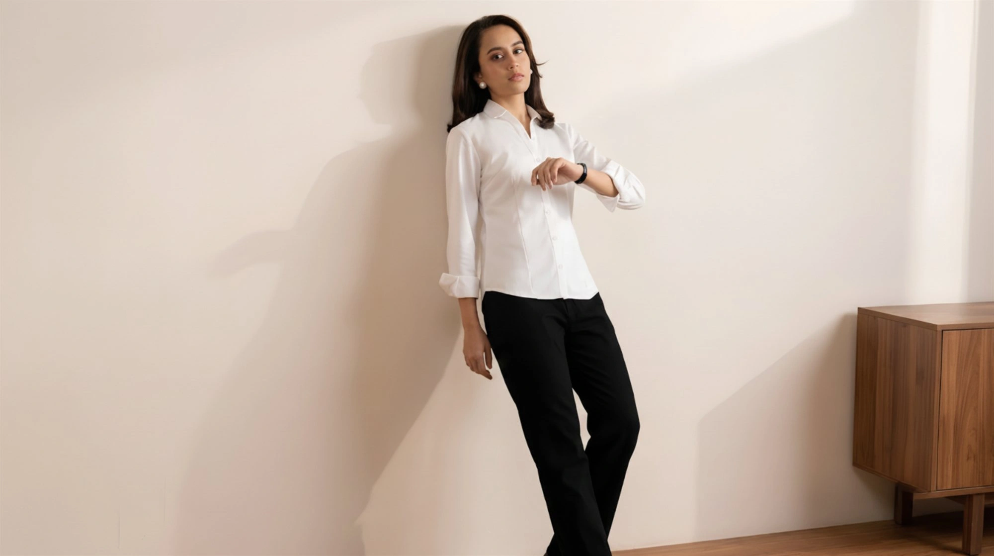 Model wearing Orphic women's white shirt with sleeves rolled