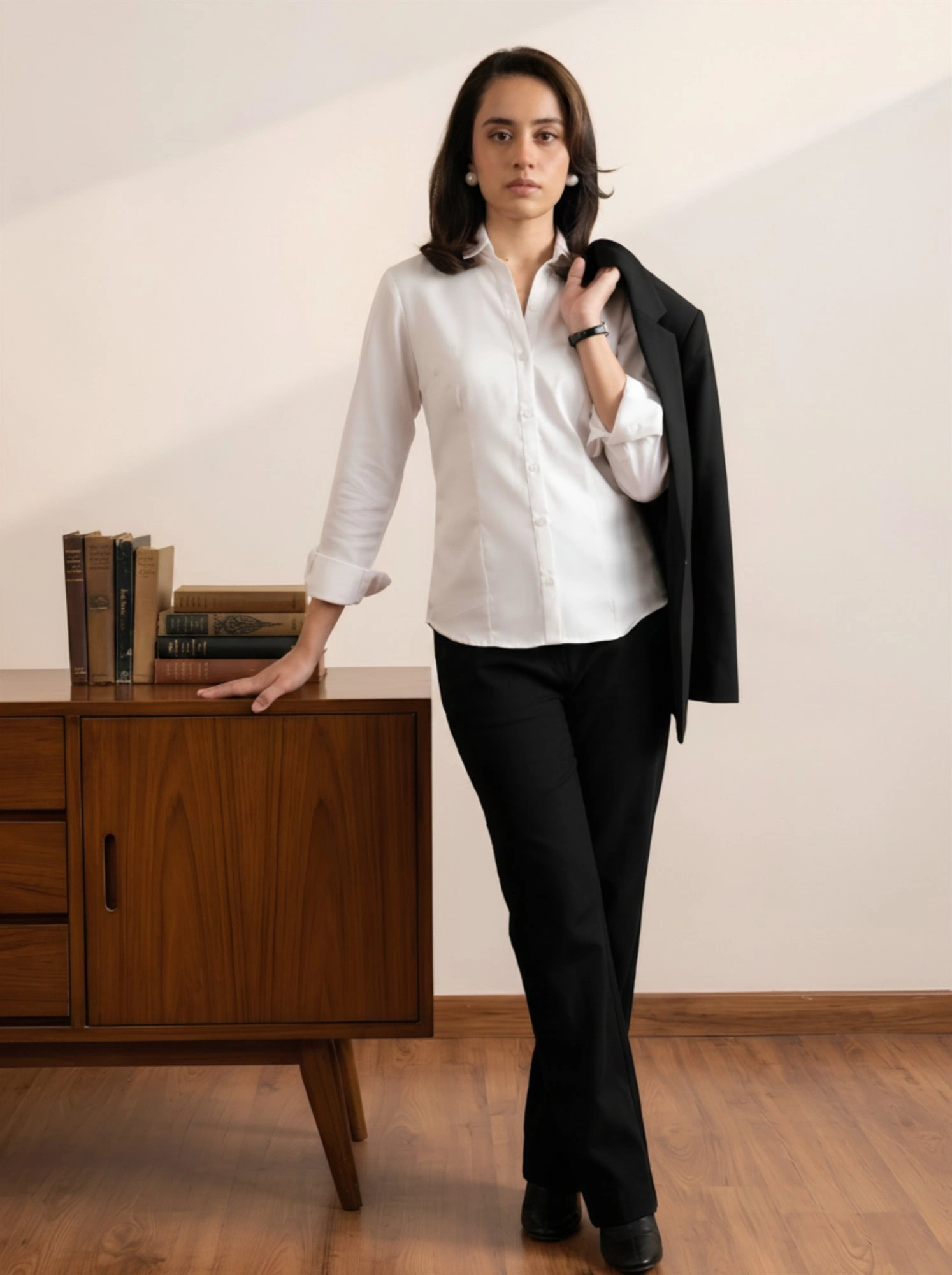 Women's white shirt styled with black trousers and blazer